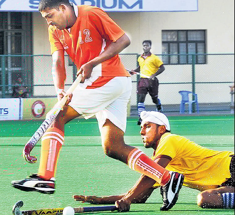 Tough tackle MEGs Monnappa (left) goes past PCTCs Ekam Singh during their Super Division match. DH PHOTOtough tackle MEGs Monnappa (left) goes past PCTCs Ekam Singh during their Super Division match. DH PHOTO