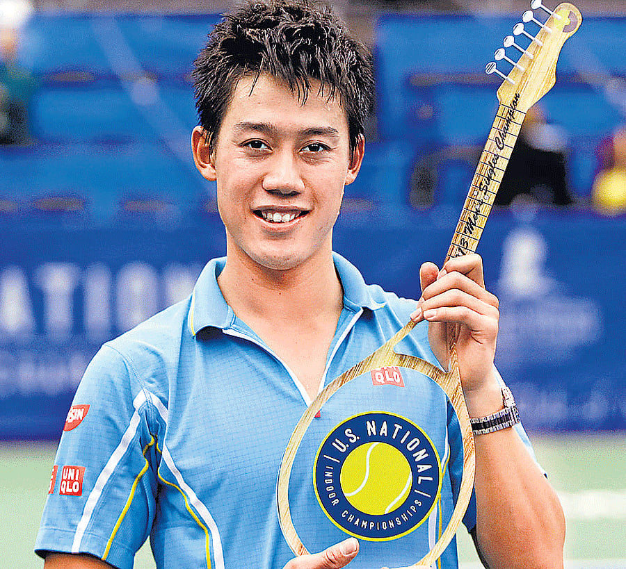 Strings of Success: Japans Kei Nishikori poses with the Memphis Open trophy after defeating Spaniard Feliciano Lopez in the final on Sunday. AFP