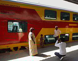 A passenger takes pictures of the double-decker train during a trial run between Chennai-Bangalore route in Bengaluru railway station on Friday. The train is expected to begin operations in March. PTI Photo