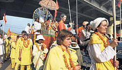 Foreign devotees taking part in a procession at Maha Kumbh.