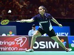 India's Saina Nehwal returns to Thailand's Intanon Ratchanok during their All England Open Badminton Championships women's singles semi-final match in Birmingham, central England, on March 9, 2013. AFP PHOTO