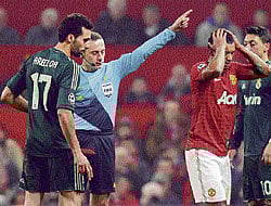OH NO! Uniteds Nani (2nd from right) receives red card from referee Cuneyt Cakir for a challenge on Real Madrids Alvaro Arbeloa in the Champions League. AFP