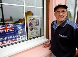 Bill Poole aged 85, Falkland Islander, stands on March 7, 2013 in Port Stanley, beside posters calling to vote YES to remain British in the referendum which will be held on the Falklands Islands (Malvinas, for Argentina), on March 10 and 11, asking the islanders whether they wish to retain their status as a self-governing British overseas territory. Argentina says the vote is illegal. Great Britain has held the islands since 1833, but Argentine forces invaded them in 1982, prompting then British prime minister Margaret Thatcher to send ships and troops to reclaim control. The 74-day war left 649 Argentines and 255 Britons dead. AFP PHOTO