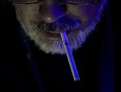 A man smokes during a concert in Vina del Mar, Chile. AFP PHOTO