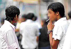 Stub the butt: People can lodge complaints on the helpline against those found smoking in public places. DH Photo