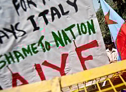 Indian Left-party activists hold placards and shout slogans during a protest near the Italian Embassy in New Delhi on March 13, 2013. India's Prime Minister Manmohan Singh warned Italy that there would be 'consequences' unless it returned two of its marines who skipped bail while on trial in New Delhi for murder. AFP PHOTO