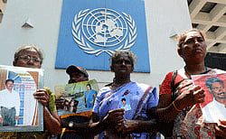 Sri Lankan demonstrators hold portraits of missing relatives during a protest outside the United nations office in Colombo on March 13, 2013. A Roman Catholic priest led families of victims to hand over a petition to the UN office as Sri Lanka faced renewed censure at the on-going UN Human Rights Council (UNHRC) sessions in Geneva. Priest Sebamalai Emmanual said hundreds of minority Tamils were stopped from leaving the northern town of Vavuniya a week ago by police and security forces who blocked a planned peaceful demonstration in the capital. AFP PHOTO
