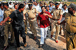 dissent: Congress workers raise slogans as police escort Medical Education and District In-charge Minister S A Ramdas near hi-tech crematorium at Vijayanagar in Mysore on Wednesday.