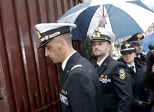 Italian marines Massimiliano Latorre, left, and Salvatore Girone arrive at the military prosecutor's office in Rome Wednesday, March 20, 2013. A military prosecutor in Rome is questioning the two Italian marines India is insisting return to face trial in the deaths of two fishermen. India's Supreme Court barred the Italian ambassador from leaving the country after the Italian government refused to return the marines to India. The two have been charged in India with killing two Indian fishermen whom the marines say they mistook for pirates. AP Photo