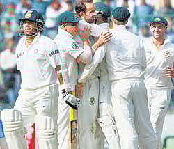 Good job: Australias Nathan Lyon (centre) celebrates with team-mates the dismissal of Sachin Tendulkar on Saturday. pti