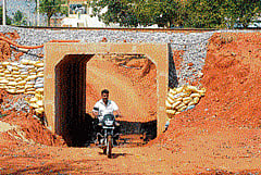 muddy stretch: The residents are facing a lot of inconveniences due to the construction of the underpass, that is both narrow and short near Kuppahalli village in Chikkaballapur taluk. DH Photo