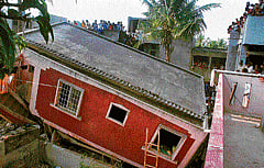Salvage effort: Fire personnel look for people trapped under the debris of a building which collapsed following an LPG cylinder blast in Belgaum on Thursday. A victim of the blast is pulled from the rubble (right).  dh photos