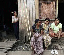 Former Pakistani President Pervez Musharraf, center, surrounded by guards arrives in a court in Karachi, Pakistan on Friday, March 29, 2013. An angry lawyer threw a shoe at former President Pervez Musharraf as he headed to court in southern Pakistan on Friday to face legal charges following his return to the country after four years in self-imposed exile, police said. (AP Photo