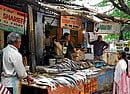 Unkept promise:  Vendors from Cox Town Market have been forced to sell their wares on the pavement. DH Photo