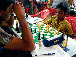Pragnananda R from Tamil Nadu contemplates a move against Vinayak Kulkarni of Karnataka in the Open Chess tournament in Mysore on Tuesday. dh photo