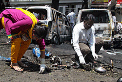 Forensic officials collect evidence at the scene of a blast near Bharatiya Janata Party (BJP) office in Bangalore April 17, 2013. At least 16 people were injured after a blast near the BJP office in Bangalore on Wednesday, police said. REUTERS