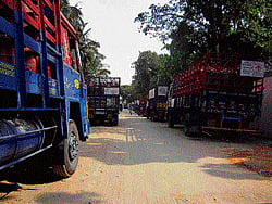 Trucks loaded with LPG cylinders parked on Singayyanapalya Main Road. DH Photo