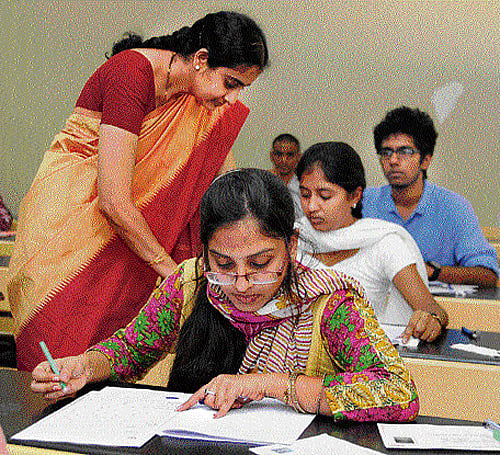 Attentive: Students write Common Entrance Test (CET) at a college in Bangalore on Wednesday. DH Photo