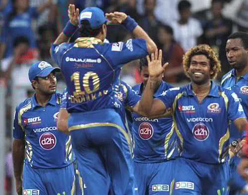 Mumbai Indian cricketers celebrate the dismissal of Chennai Super Kings batsman Morris during IPL 6 in Mumbai on Sunday. PTI Photo