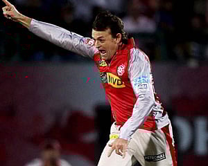 Kings XI Punjab's Adam Gilchrist celebrates wicket of Mumbai Indians' Harbhajan Singh during the IPL 6 match in Dharamshala on Saturday.PTI Phot