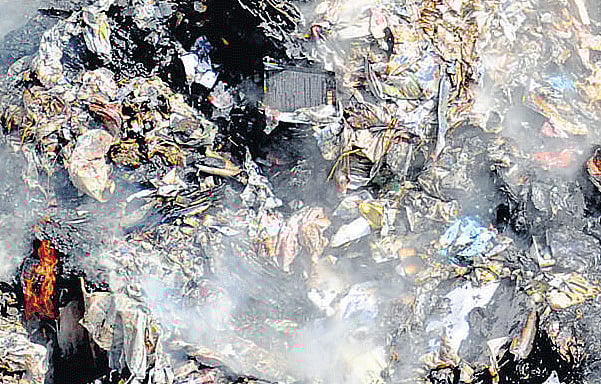 Problematic : Garbage being burnt on Mysore Road. DH Photo by Srikanta Sharma R