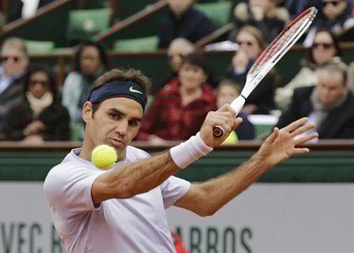 Federer of Switzerland hits a return to Carreno-Busta of Spain during their men's singles match at the French Open tennis tournament in Paris Reuters Image