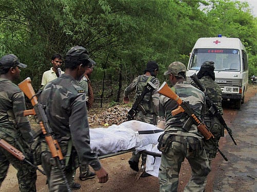 Security personnel carry the body of one of the victims of Saturday's Maoist attack in a densely forested area in Bastar, about 345 kilometers of Raipur, Chhattisgarh, Sunday, May 26, 2013. Officials reacted with outrage Sunday to an audacious attack by about 200 suspected Maoist rebels who set off a roadside bomb and opened fire on a convoy carrying the ruling Congress party leaders and members in Chattisgarh, killing at least 24 people and wounding 37 others. AP Photo