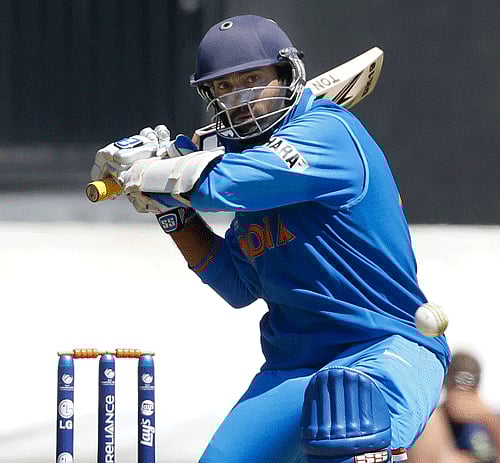 India's Dinesh Karthik plays a shot for four off the bowling of Australia's Mitchell Marsh during a warm up cricket match for the upcoming ICC Champions Trophy between India and Australia at the Cardiff Wales Stadium in Cardiff, Wales, Tuesday, June 4, 2013. (AP Photo)
