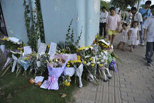 Flowers are seen at the site of Friday's bus fire in Xiamen reuters Image