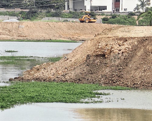 Desilting of the Devasandra lake for the past one month has made matters worse for residents. dh photo