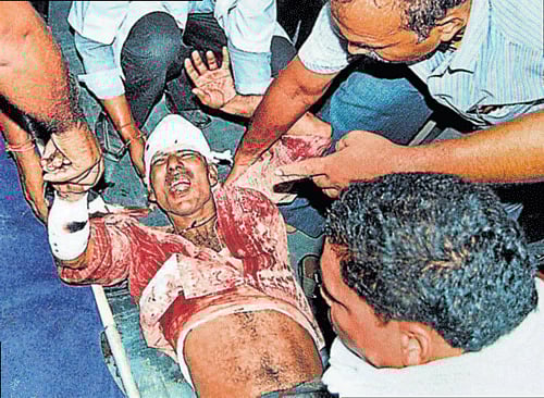 People  carry an injured passenger of  Dhanbad-Patna Intercity Express train which was attacked by Maoists near Kundhar halt in Jamui district of Bihar on Thursday. PTI