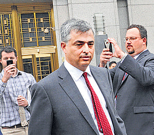 Eddy Cue, Apple's senior VP of Internet Software and Services (centre) exits Manhattan federal court in New York. AP