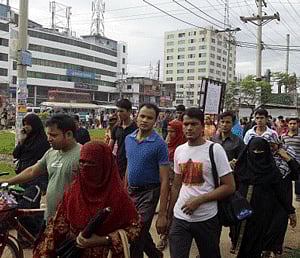 Bangladesh garment workers arrive for work in the morning in Dhaka, Bangladesh, Thursday, June 13, 2013. Bangladeshi garment factories are routinely built without consulting engineers. Many are located in commercial or residential buildings not designed to withstand the stress of heavy manufacturing. Some add illegal extra floors atop support columns too weak to hold them, according to a survey of scores of factories by an engineering university that was shown to The Associated Press. AP Photo
