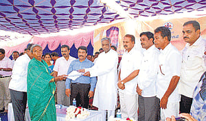 reaching the facilities: Revenue and District In-Charge Minister V Sreenivas Prasad distributes sanction letters during the launch of 'Pension Adalat' at Kudlapur, Doddakaulande Hobli, Nanjangud taluk, Mysore, on Sunday. Deputy Commissioner Ramegowda, assistant commissioner Basavaraj, Chamarajanagar MP R Dhruvanarayan, Zilla Panchayat President Ka Pu Siddaveerappa, member Sindhuvalli Kempanna and others are seen. dh photo
