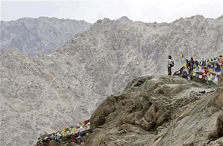 A tourist stands on a hilltop overlooking Leh city from Namgyal Tsemo Gompa monastery in Leh, capital of Ladakh. Reuters