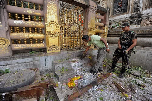 Security personnel inspecting the explosion site after a serial blast in Mahabodhi temple complex at Bodhgaya on Sunday. PTI photo