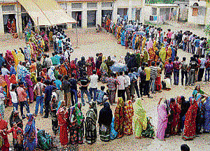 Women stand in a queue to cast their votes at a polling station in the Bankura district of West Bengal on Thursday. PTI