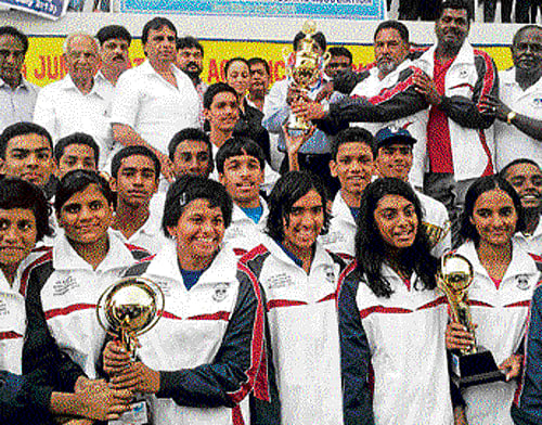 triumphant again: Karnataka team celebrates its overall success. RIGHT: Karnataka's Shraddha Sudhir who won the girls 200M breaststroke.