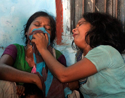 Women mourn the death of their children who died after consuming contaminated meals given to children at a school on Tuesday at Chapra in Bihar  on July 17, 2013. At least 20 children died and dozens were taken to hospital with apparent food poisoning after eating a meal provided for free at their school in the district of Chapra, the education minister said on Wednesday, sparking violent protests. REUTERS
