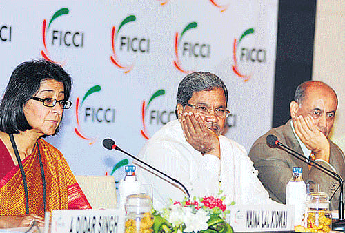 (From left) Ficci President Naina Lal Kidwai, Karnataka CM  K Siddaramaiah, Ficci immediate past president R V Kanoria and Ficci Karnataka State Council Chairman Avinash Vashistha in Bangalore on Monday. DH Photo