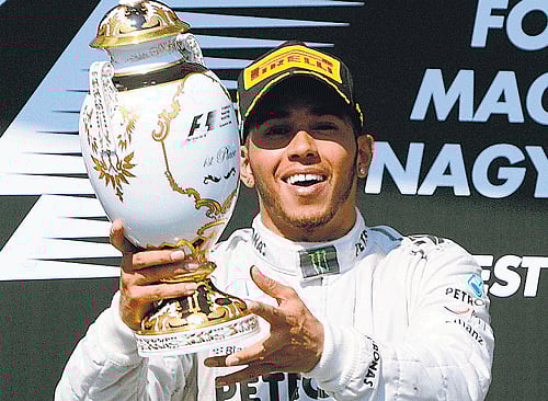 take a bow: Briton Lewis Hamilton celebrates after winning the Hungarian Grand Prix in Budapest on Sunday. AP