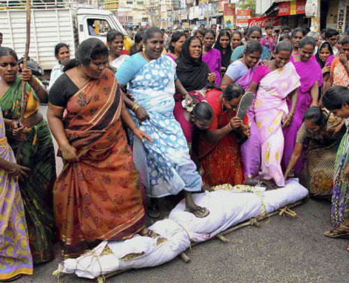 Women activist, with an effigy of AICC President Sonia Gandhi, protest against creation of Telangana, in Chittoor on Thursday. PTI Photo