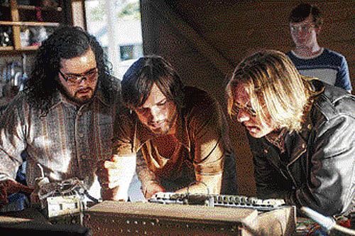 Pioneers: The brilliant Steve Wozniak (Josh Gad), Steve Jobs (Aston Kutcher) and Rod Holt (Ron Eldard) work on the Apple II prototype.