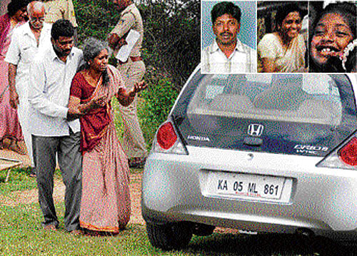 Family members grieve near the car in which Sandeep, Archana and Aditi committed suicide at Devanahalli near Bangalore on Friday. DH Photo / S K Dinesh