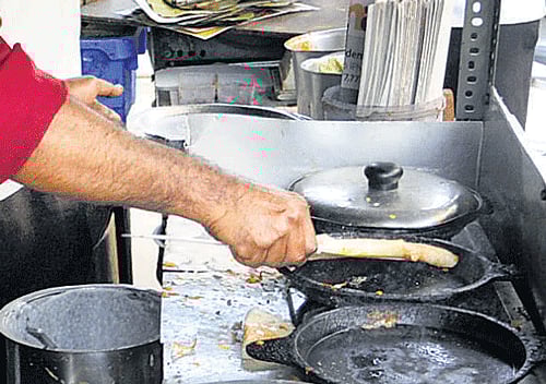 in demand: A vendor preparing dosa.
