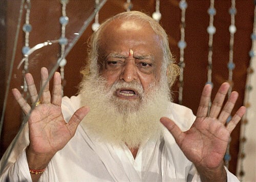 Asaram Bapu, accused of sexually assaulting a minor girl, is escorted after he was produced at court in Jodhpur on Monday. PTI Photo