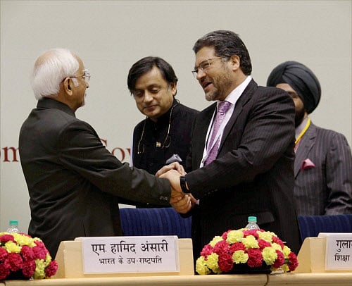 Vice President Hamid Ansari exchanges greetings with Education Minister of Afghanistan Gulam Farooq Wardak during the International Literacy Conference on Alliance for Literacy, Peace and Development in South Asia, in New Delhi on Saturday. MoS for HRD Shashi Tharoor is also seen. PTI Photo