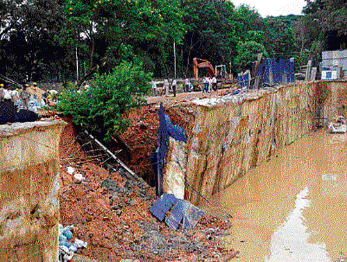 down comes the wall: The retaining wall at the construction site of a building, belonging to the Central Public Works  Department, collapsed at Domlur Layout on Tuesday. No casualties were reported. dh Photo