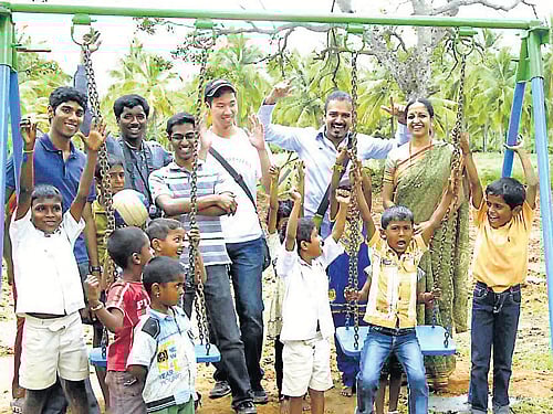 Students of Hanumathapura Government Primary School with the volunteers of Bevu Foundation. dh photo
