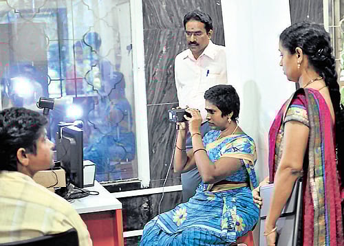 futile exercise? A citizen gives her iris image as part of Aadhaar enrolment in Bangalore on Wednesday. dh Photo
